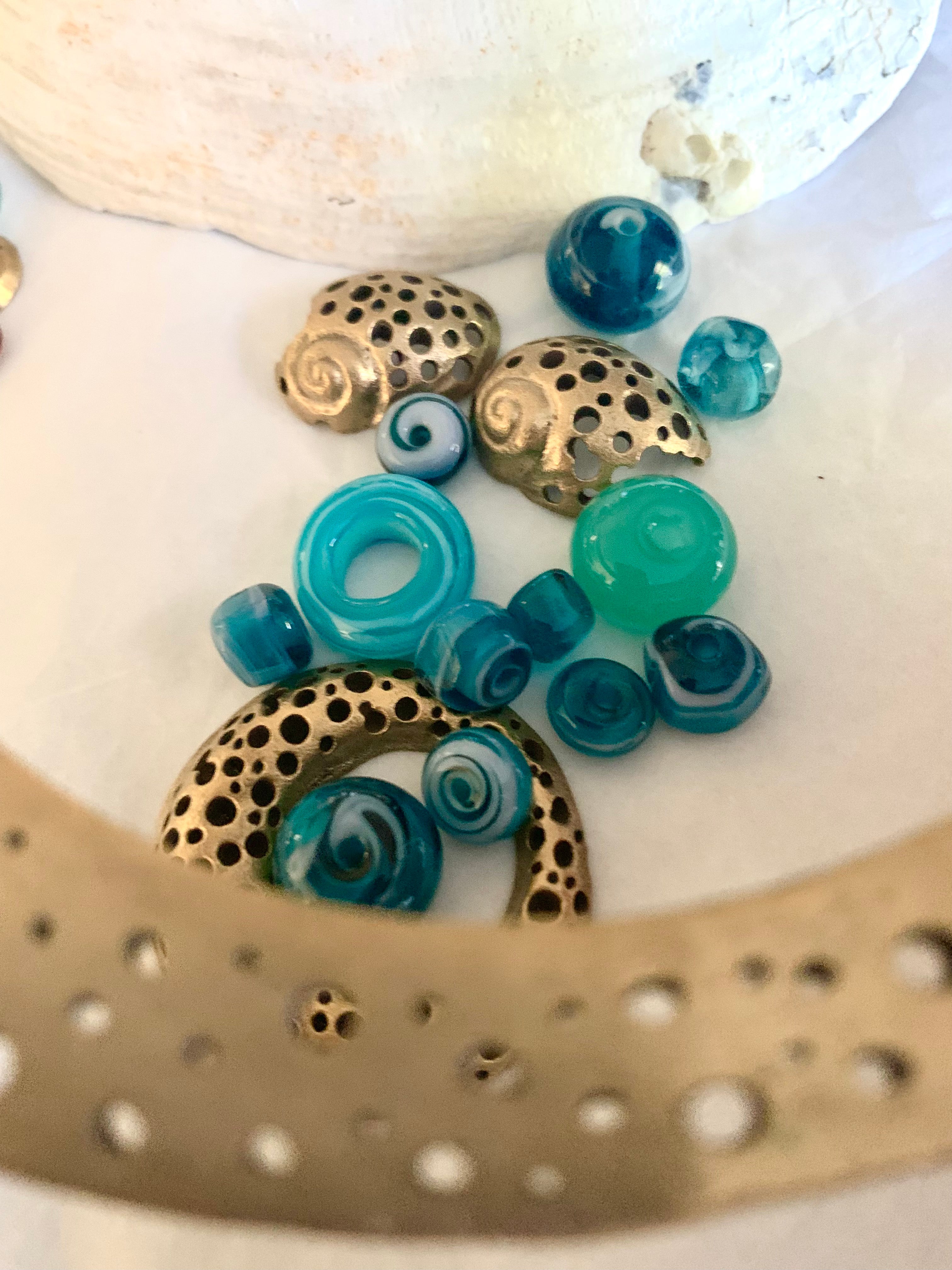 Bronze artisan made pieces with blue glass beads
