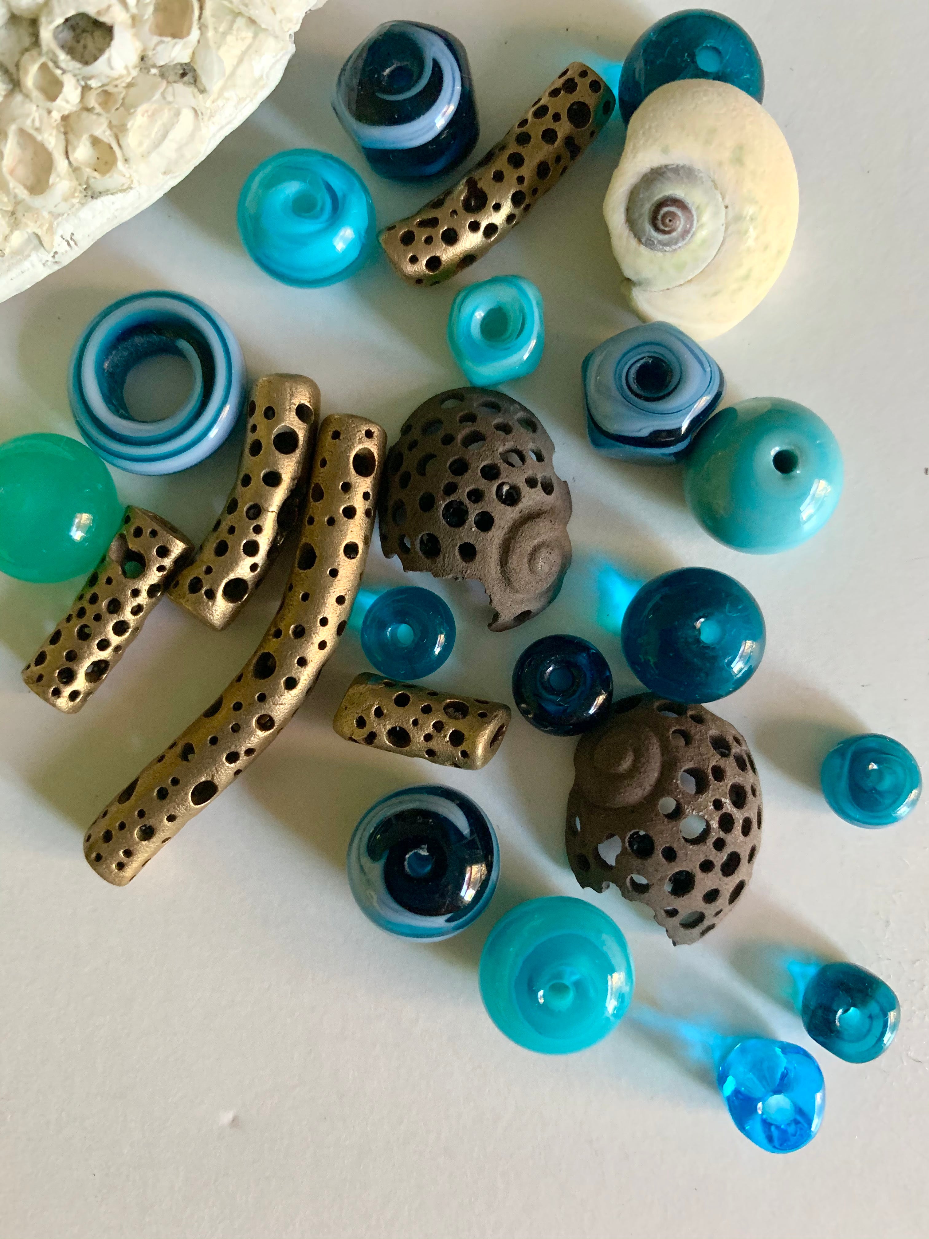 Moonsnail bronze jewelry pieces with blue art beads and seashells
