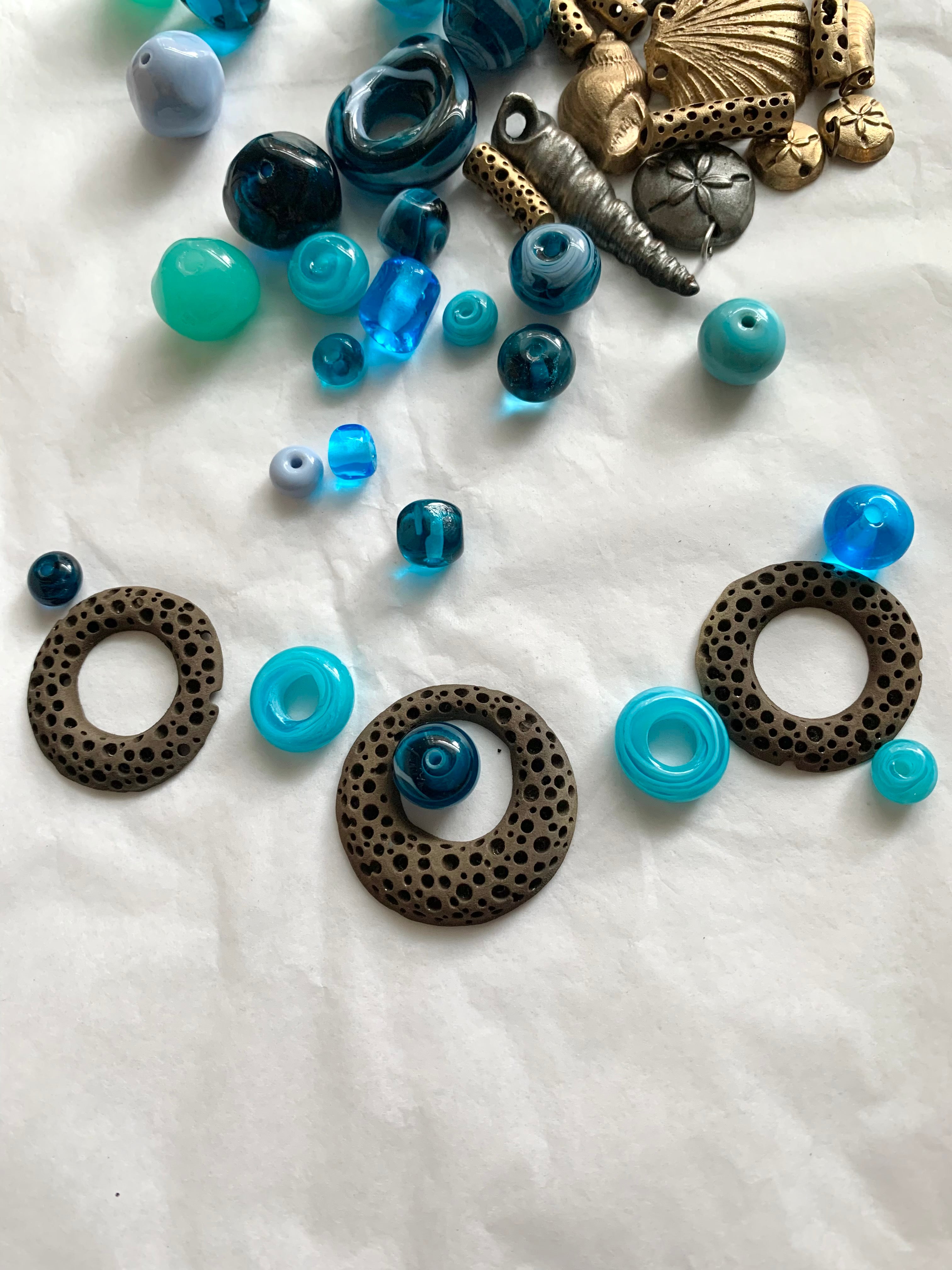 Blue glass artisan made beads with unfinished bronze rings for necklace