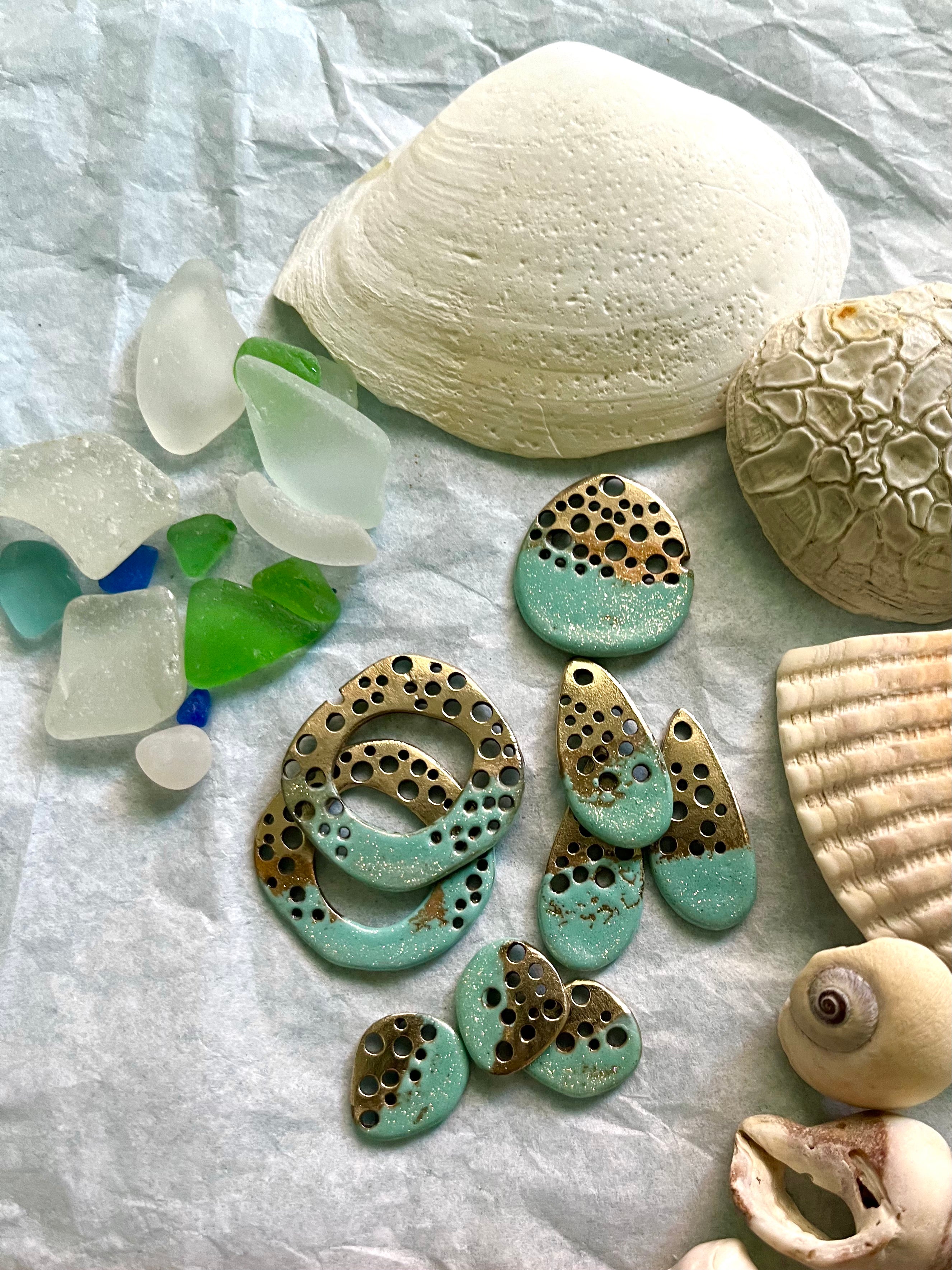 Seafoam green bronze jewelry pieces with seashells and glass