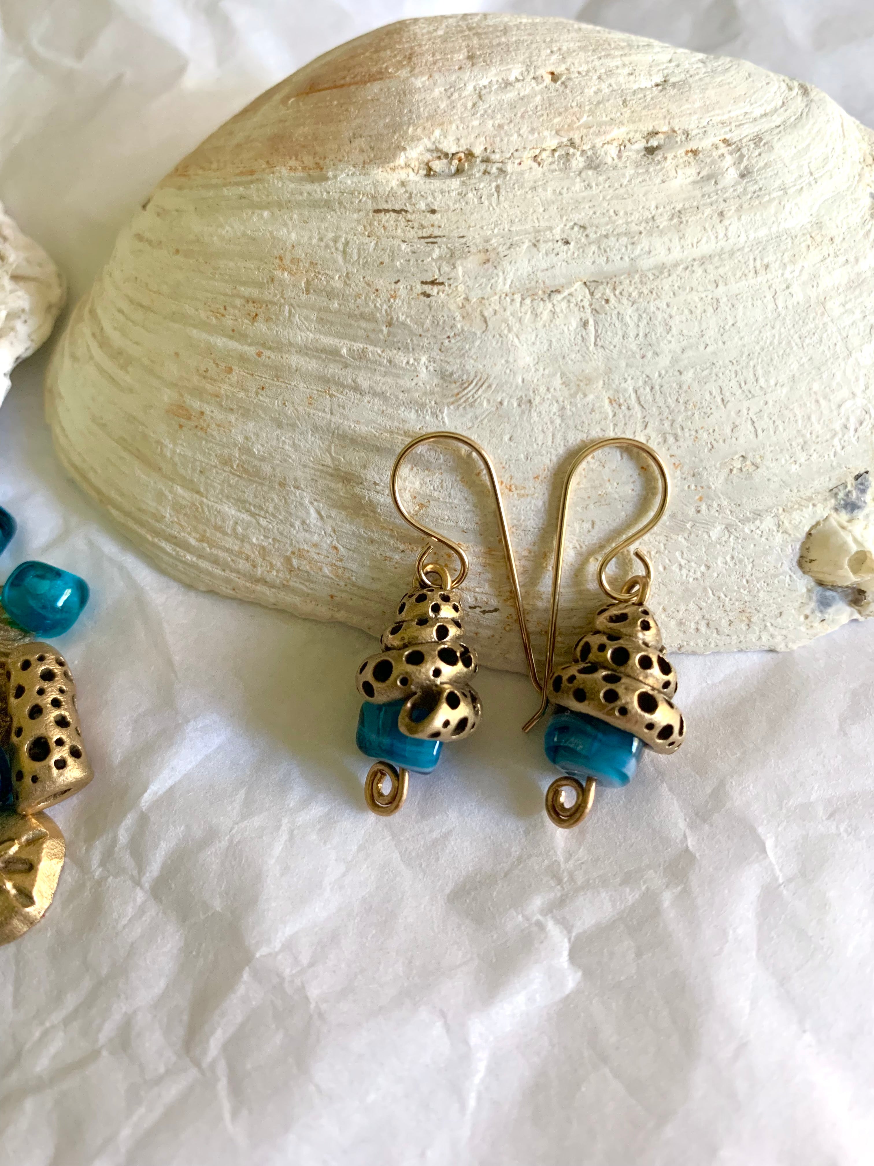 Shell inspired bronze earrings with blue artisan made glass beads