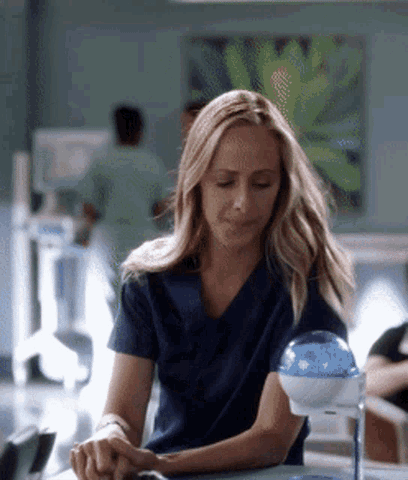 Character on Grey's Anatomy using Germstar hand sanitizer station
