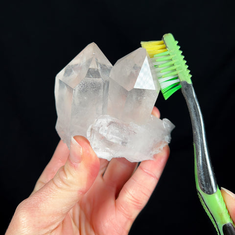 Using a toothbrush and water to clean crystals