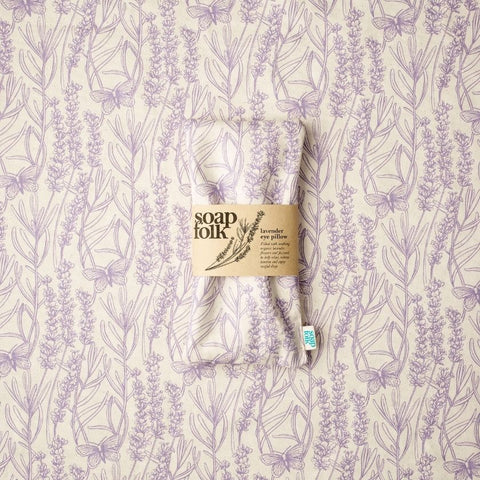 Soap Folk Lavender Eye Pillow Resting on Organic Cotton Fabric
