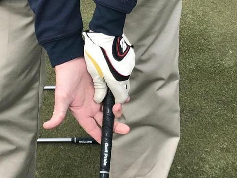 Slide right hand under golf club grip