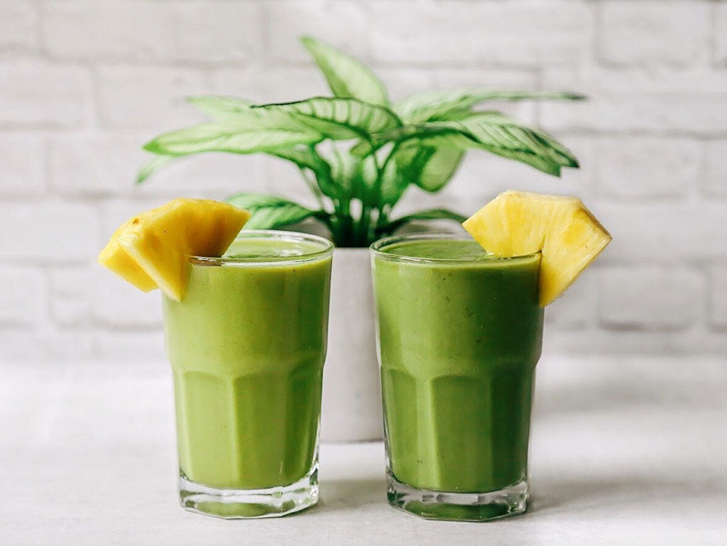 Two tropical matcha smoothies with pineapple