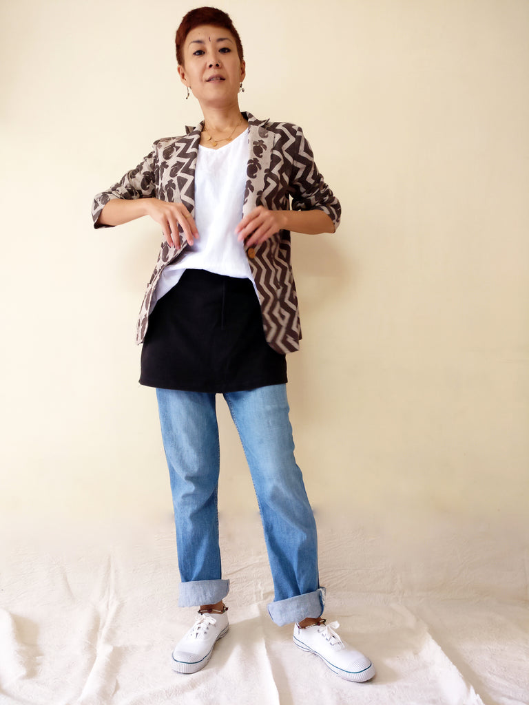 image of a styling with a black side-striped cotton jersey skirt with jeans