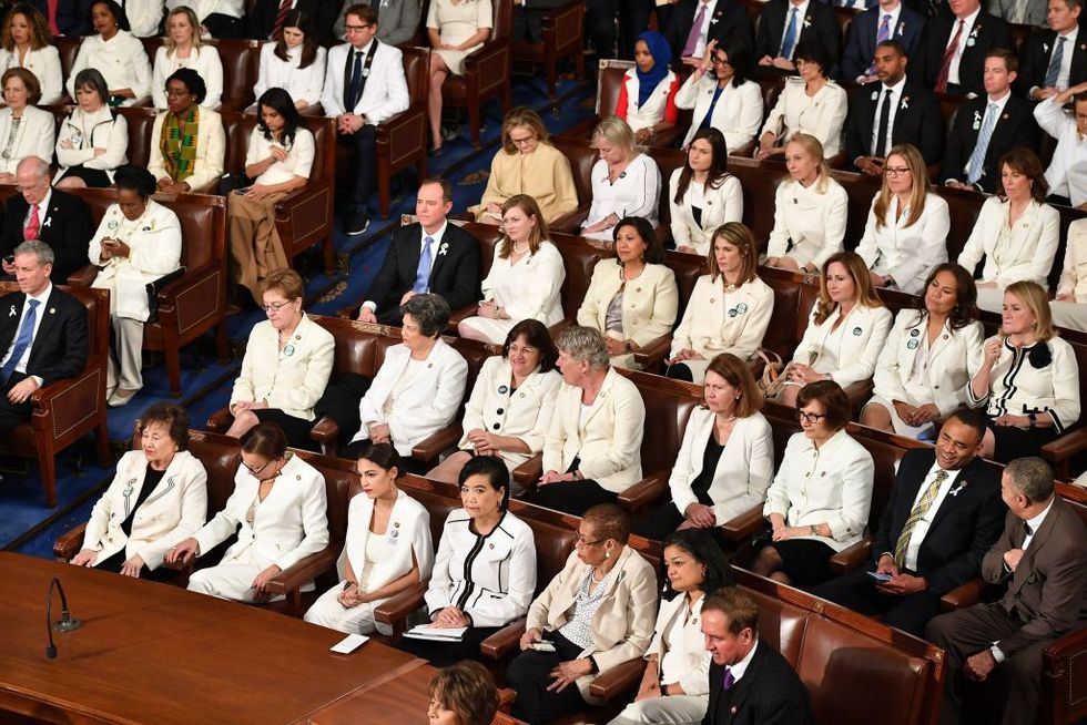 women members in white suits at administering oaths in 2019