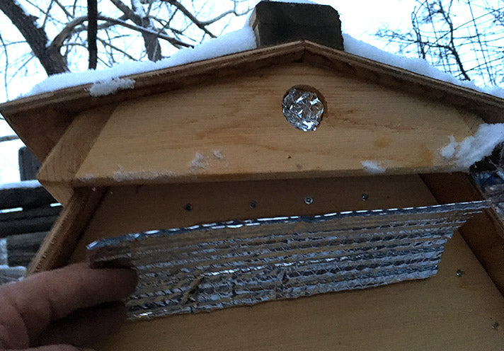 In colder temperatures you can add reflective bubble insulation in the gap between the ventilated roof and hive.