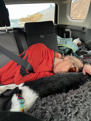 Hannah sleeping in the car with her dog.