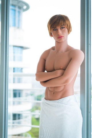 Sexy male sex doll standing with arms crossed and towel over his penis