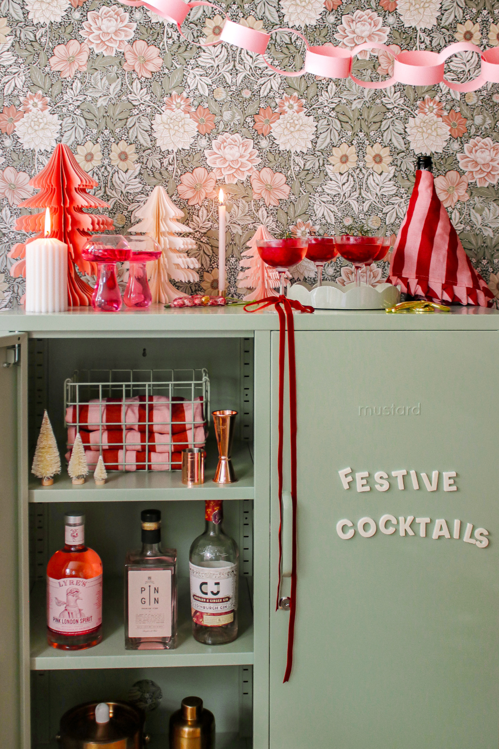 A Sage Midi has one door open. There is a cocktail shaker and bottles of spirits inside, while Wordbits on the other door read 'festive cocktails.'