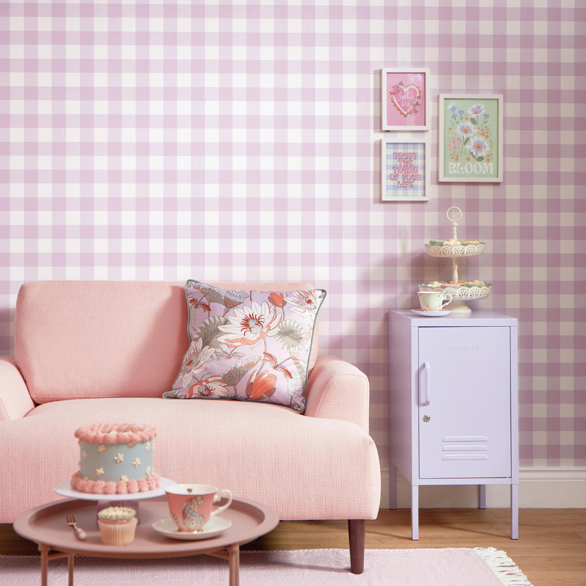 A Lilac Shorty sits in a pastel themed room with lilac gingham wallpaper and a blush couch. There is a vintage style tea party setup on the coffee table.