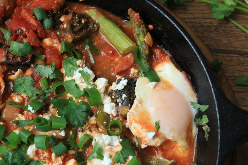 Fried egg and chorizo breakfast skillet with asparagus and green onions