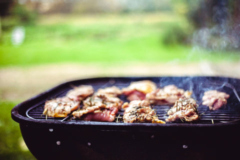 Hot smokey grill with duck breasts and other fowl seasoned with rosemary