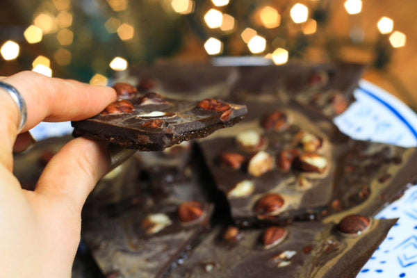 Grabbing a bite of raw chocolate bark with almonds