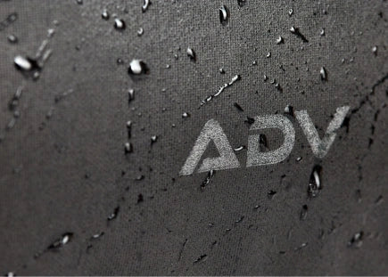 Close-up of water droplets on a surface with the letters 'ADV' visible.