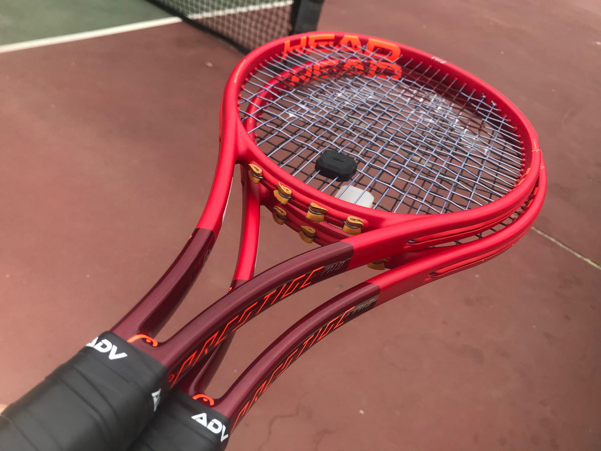 Two Red Racquets with black and white tennis dampeners and black grip tape.