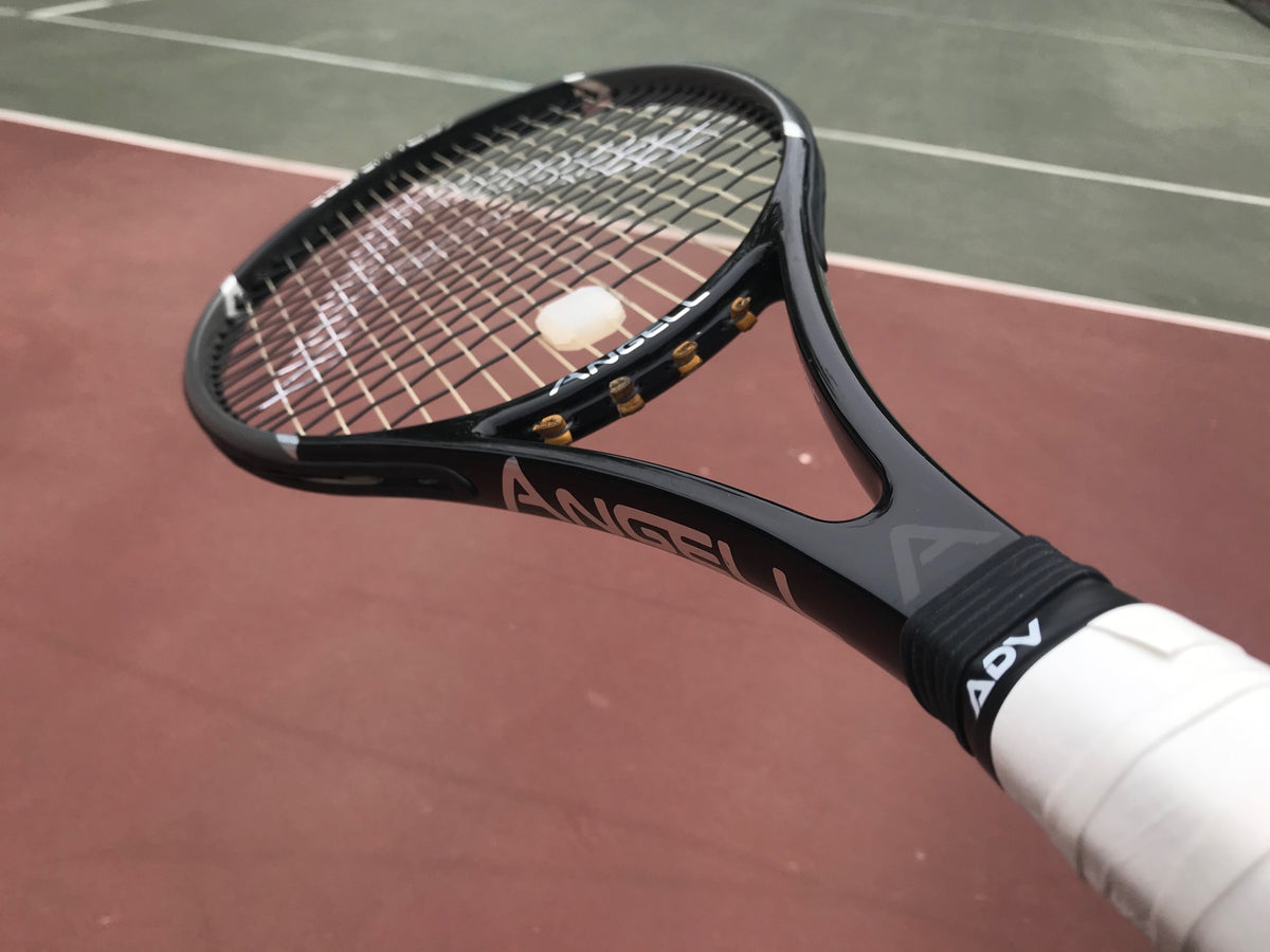 Black Racket with white vibration dampener and white grip tape on a racket handle.