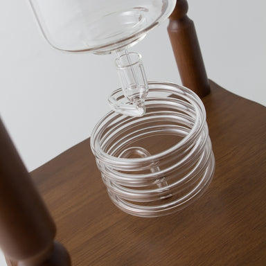 https://cdn.shopify.com/s/files/1/2275/9941/products/Yama_Glass_25_Cup_Cold_Drip_Maker_Curved_Brown_Wood_Frame_2_384x384.jpg?v=1579538653