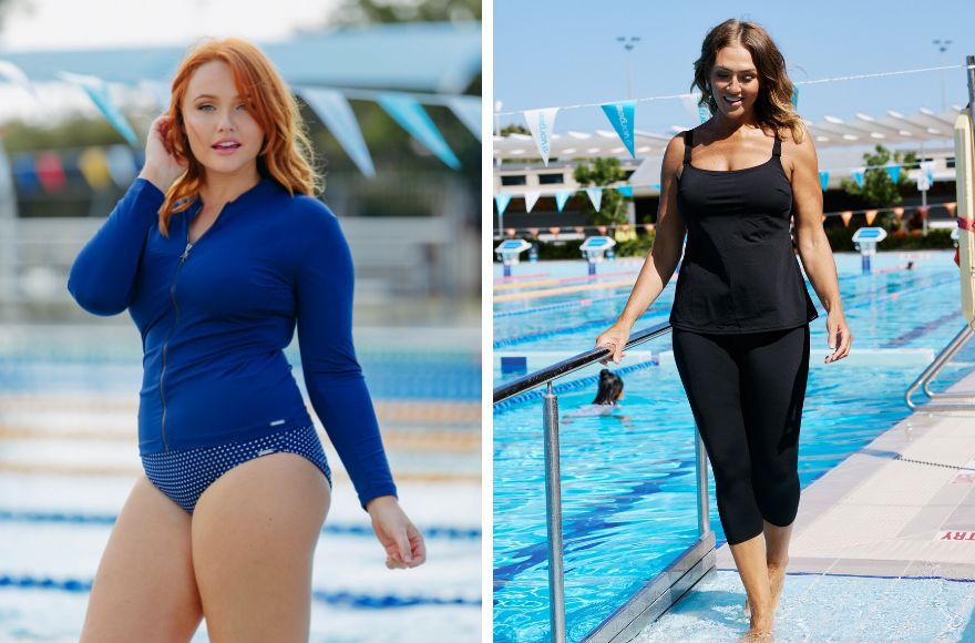 Woman with long red hair wears navy long sleeve rash vest. Woman with brown hair wears black tankini top and 3/4 swim tights.