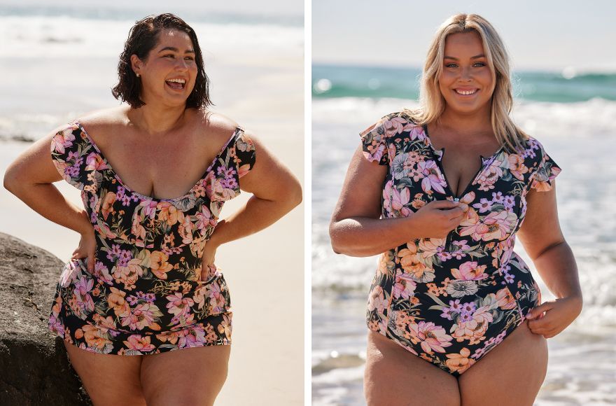 Woman with short brown hair wears black and floral swim dress. Woman with blonde hair wears zip up frill sleeve one piece in black and pink floral print.
