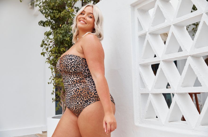 blonde woman wears Leopard print twist front strapless bandeau one piece swimsuit