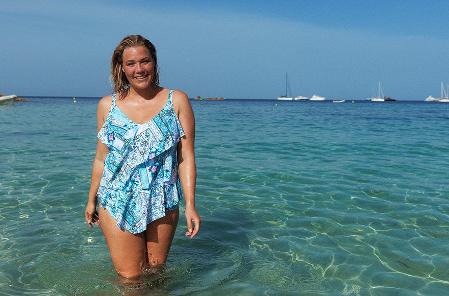 Model wearing light blue patchwork ruffle tankini in the ocean