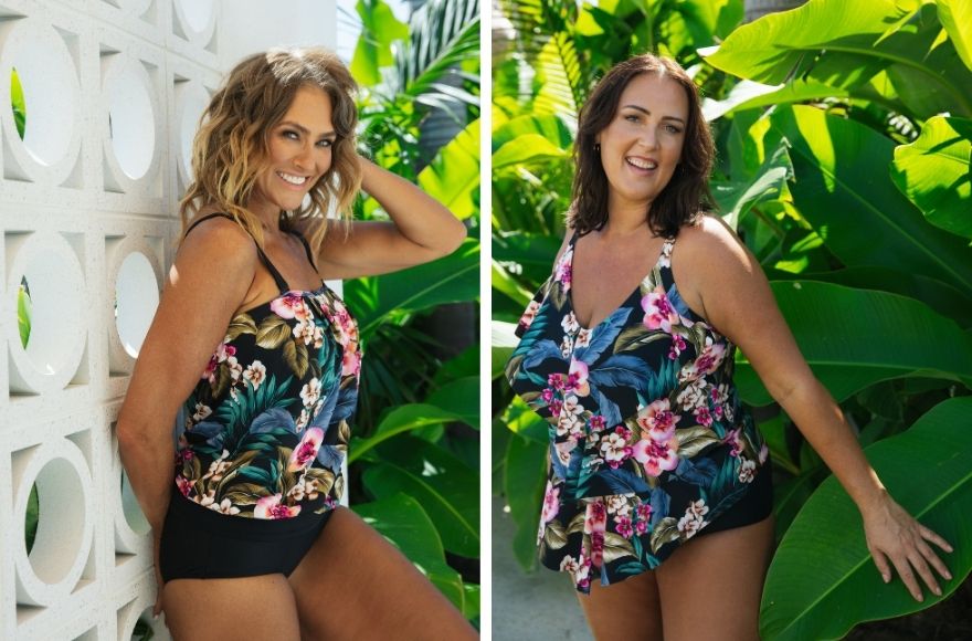 two women wear black, pink, blue and green tropical print tankini tops with black bikini bottoms