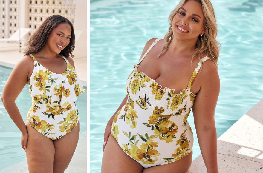 Woman with long black hair wears white one piece swimsuit with yellow flower print. Woman with blonde hair wears white one piece swimsuit with yellow floral print