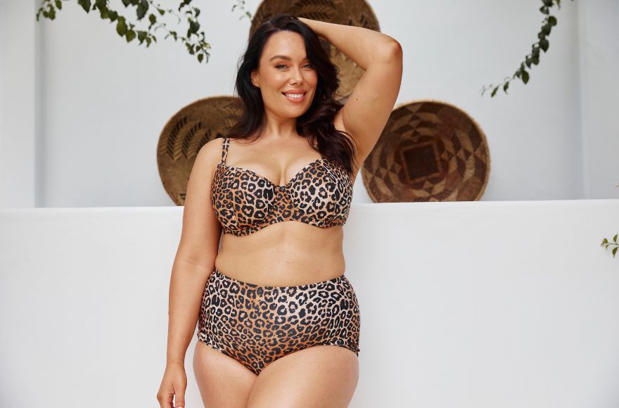 Woman with long dark brown hair wears leopard print underwire bikini top and high waisted full coverage pants