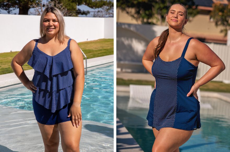 2 women pose by the pool wearing navy and white polkadot swimsuits