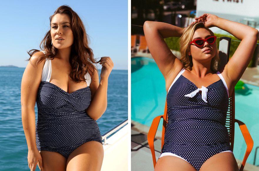 Two women wear navy and white polka dot one piece swimsuits