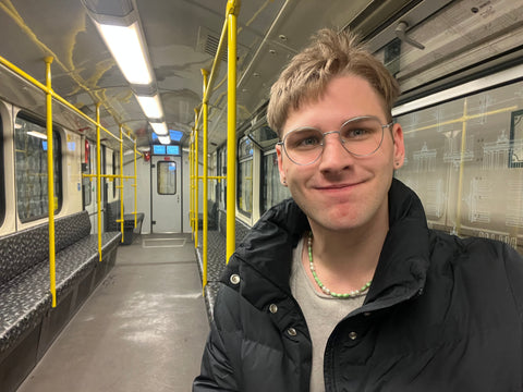 A photo of Zack smiling on a train in Berlin