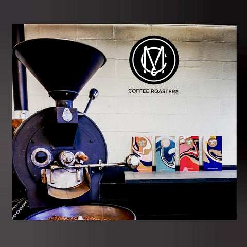 Image of a roasting drum and bags of Martinborough Coffee on display in the background.