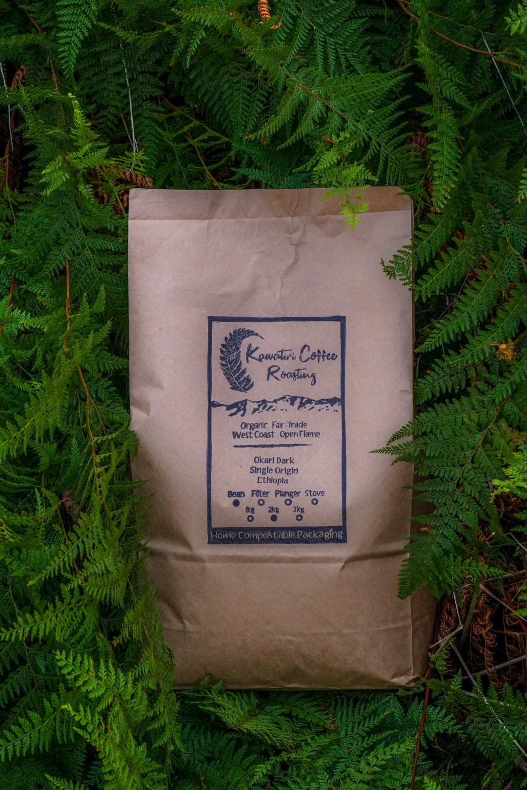 Kawatiri's new compostable bag, nestled in some lush green native New Zealand ferns.