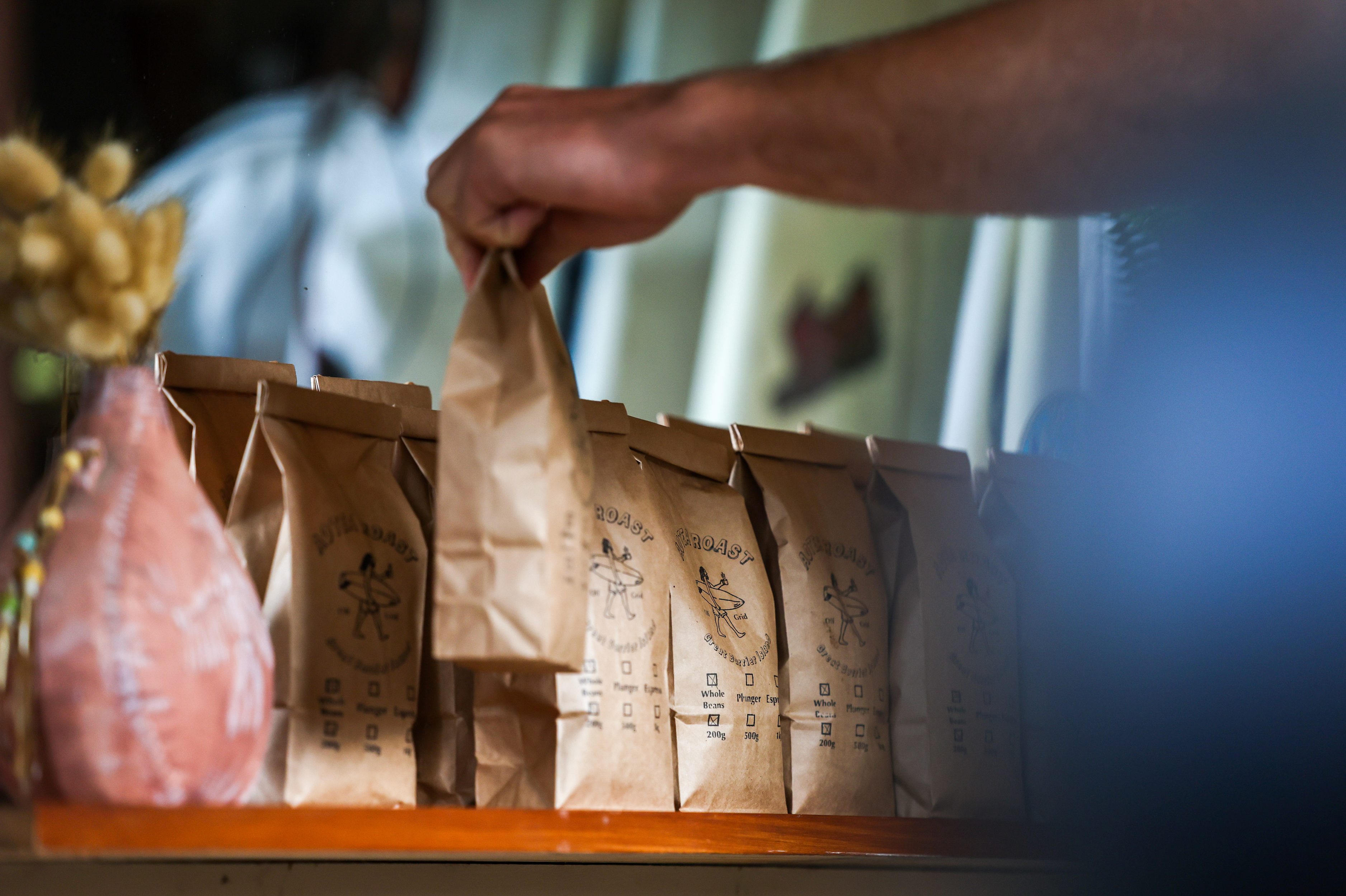 Bags of Aotea Roast coffee lined up on a bench top