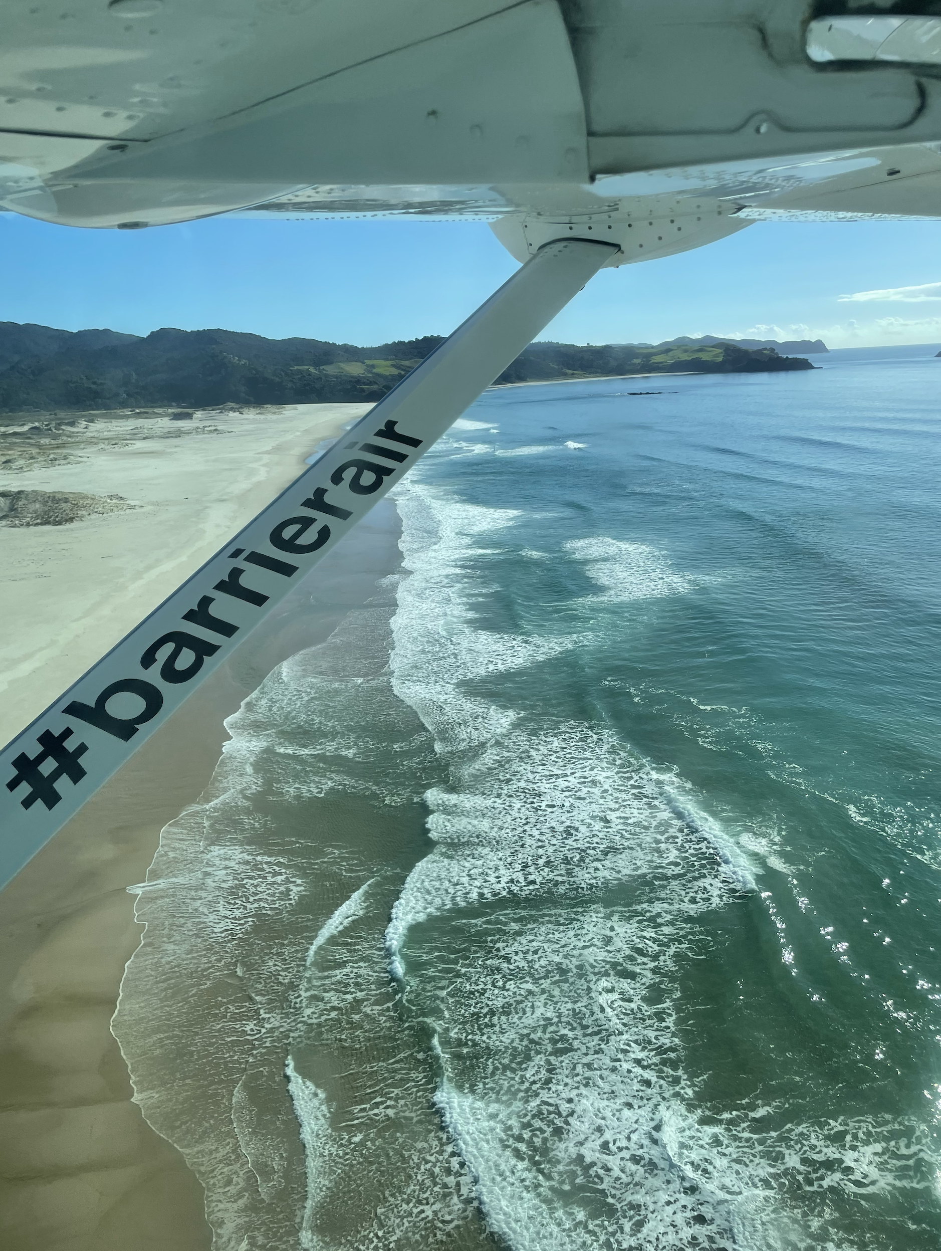 Coming into land over the beach at Aotea in a small Barrier Air plane.