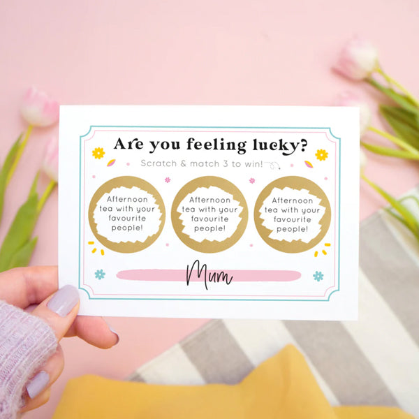 A personalised 'are you feeling lucky' scratch and reveal card showing how the card looks once the gold circles have been scratched off to reveal the message.