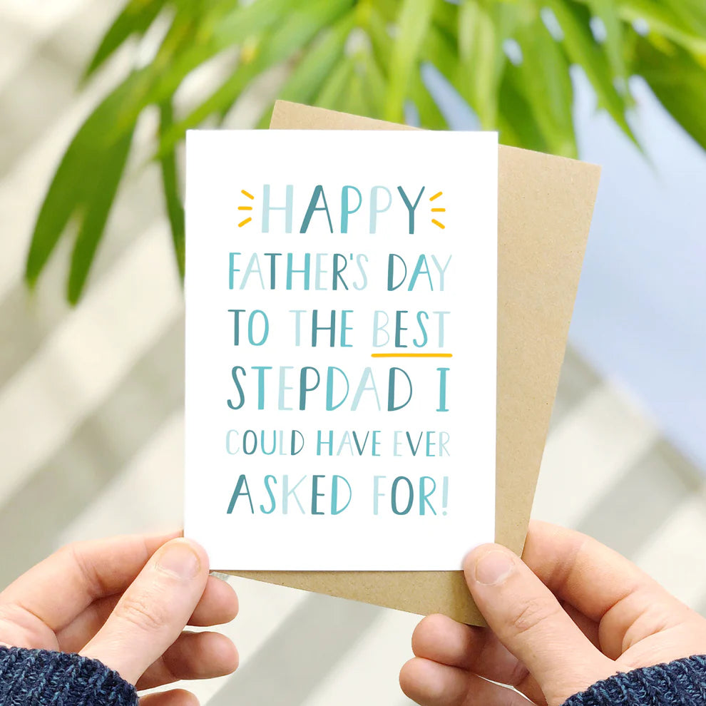 Best step dad fathers day card held in front of foliage over a striped surface