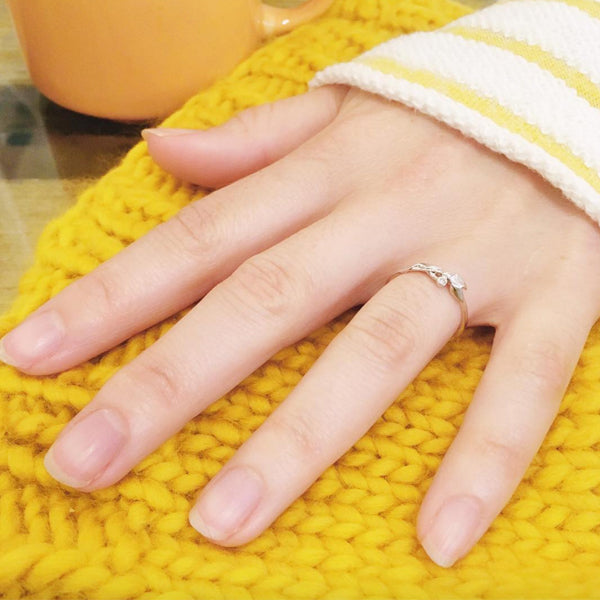 Engagement Ring from 2017 with hand on a yellow knitted hat
