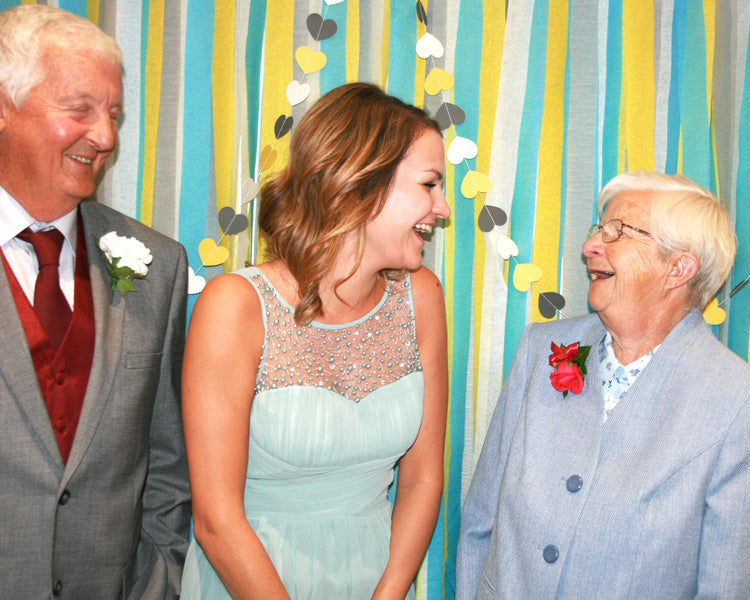 Grandad, Natasha and Nanny in the homemade yellow, blue and grey photobooth