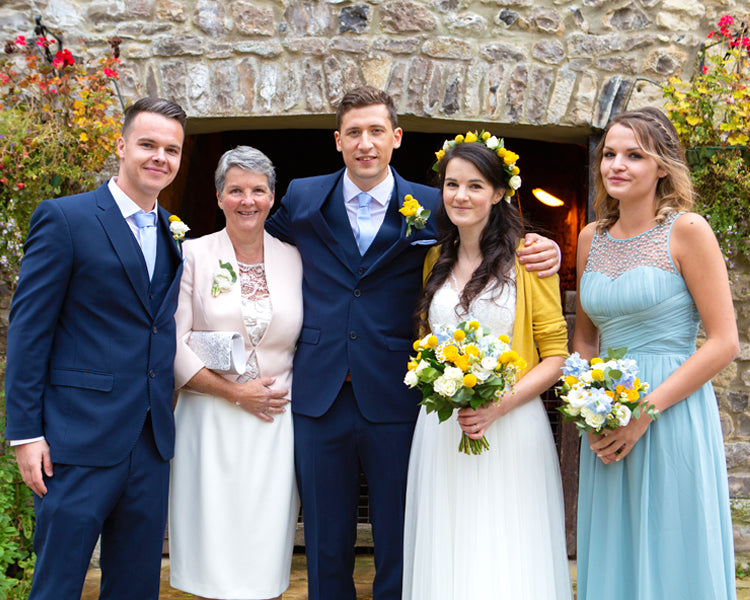 Photographs with the family. This is a line up of the brides mother, husband and sibling next to the water wheel at hornsbury mill