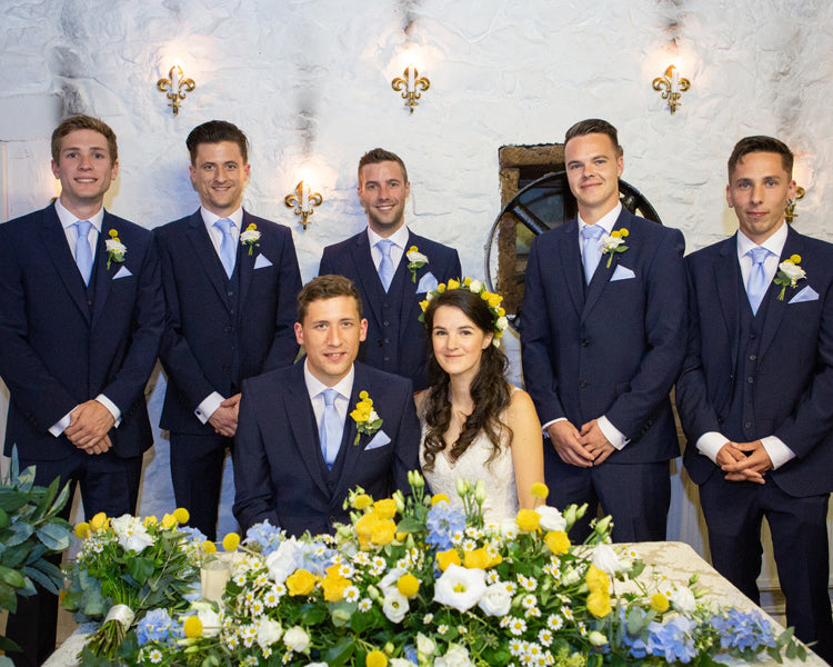 The bride and groom with all of the groomsmen at Hornsbury Mill cornloft