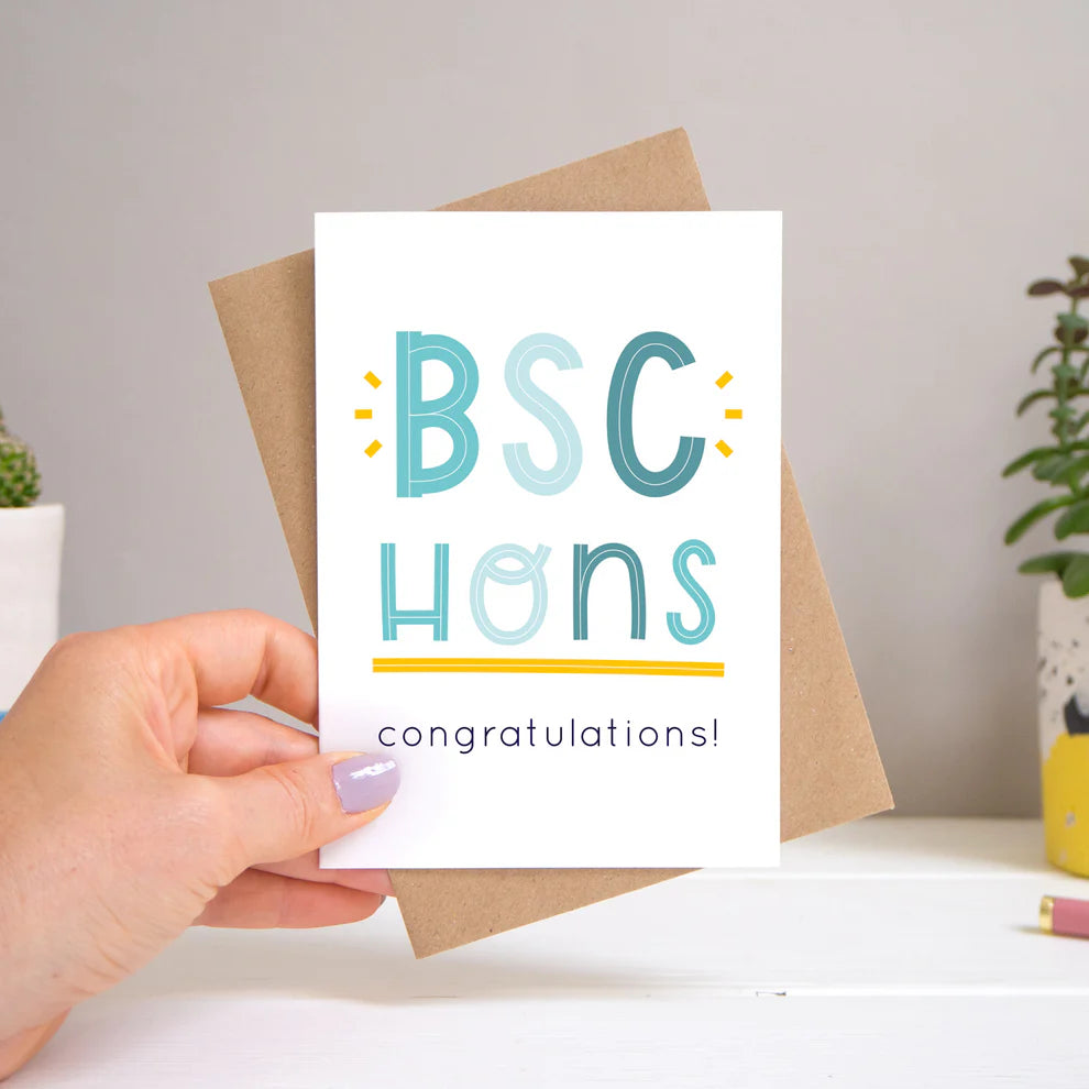 BSC Hons graduation card held against a beige background.
