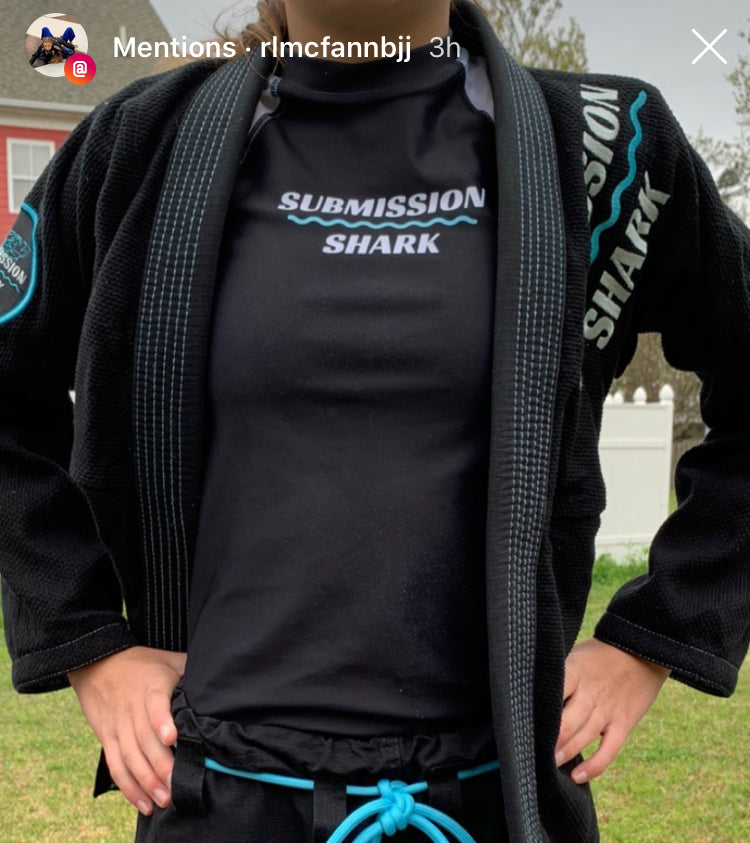 BJJ girl in a blue and black jiu jitsu gi from Submission Shark