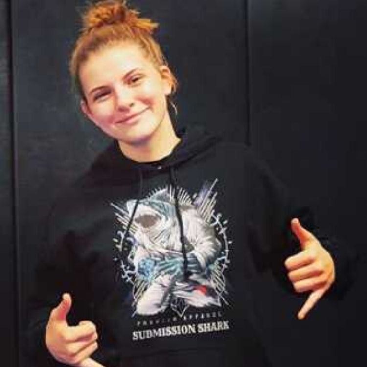 BJJ Girl Wearing a Black Submission Shark Sweatshirt at Jiu-Jitsu Practice