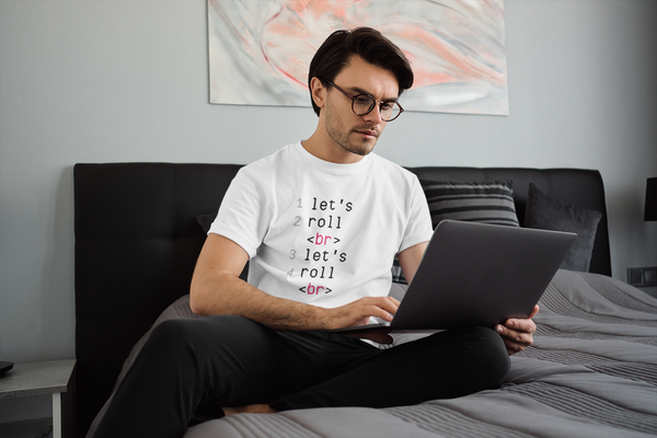 Hardworking man coding on a computer in a white BJJ T-shirt