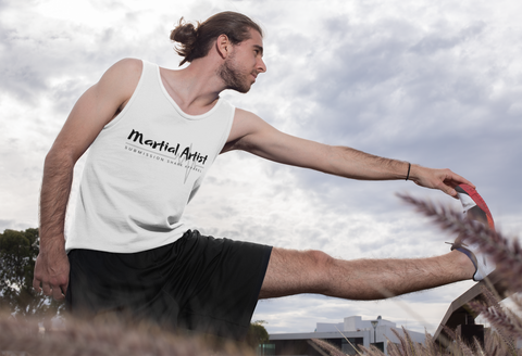 Martial Artist stretching in a white tank top