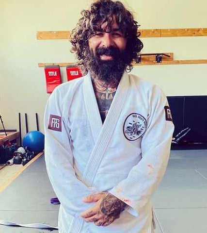 Stevie Singh Smiling In A White BJJ Gi